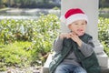 Young Mixed Race Boy Wears Santa Hat Eats Candy Cane Royalty Free Stock Photo