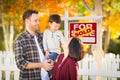 Young Mixed Race Chinese Caucasian Family In Front of Sold Sign Royalty Free Stock Photo