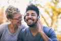 Young mixed race couple listening to music on headphones Royalty Free Stock Photo