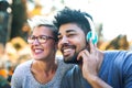 Young mixed race couple listening to music on headphones Royalty Free Stock Photo