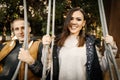 Young mixed race couple smiling happy on swing, Asian woman, Caucasian man outdoor Royalty Free Stock Photo