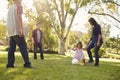 Young mixed race family playing with ball in a park, crop Royalty Free Stock Photo