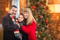 Young Mixed Race Family Portrait In Front of Christmas Tree Indoors. Royalty Free Stock Photo