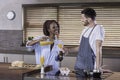 Young mixed race happy couple preparing breakfast in the kitchen cooking Royalty Free Stock Photo