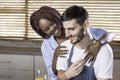 Young mixed race happy couple preparing breakfast in the kitchen cooking Royalty Free Stock Photo