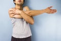 Young mixed race man stretching his arm