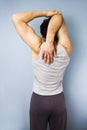 Young mixed race man stretching his shoulder