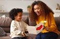 Young mixed race woman getting congratulations from son on Mothers day Royalty Free Stock Photo
