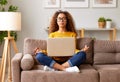 Young mixed race woman meditating with closed eyes while working or studying online in living room at home Royalty Free Stock Photo