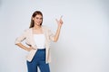 Young mixed race woman pointing to empty copy space  on white background Royalty Free Stock Photo