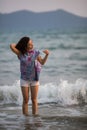 Young mixed race woman walking on the sea beach. Happy. Royalty Free Stock Photo