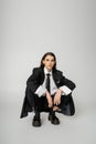 young model in black oversize suit