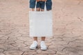 young model holding white tote bag for mockup blank template