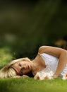 Young model laying down in grass