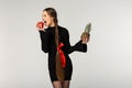 Young model with long braid and red bow wearing black dress Royalty Free Stock Photo