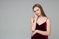 Blond girl in red dress poses showing emotions: wistfulness Royalty Free Stock Photo