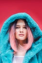 young model with pink hair posing in trendy blue fur coat, Royalty Free Stock Photo