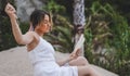 Young model posing in a summer dress and reading a book Royalty Free Stock Photo