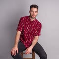 Young model with red shirt, piercings and fledgling beard Royalty Free Stock Photo