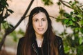 Young model woman with long straight hair wearing leather jacket posing carefree and casual on the street Royalty Free Stock Photo