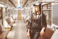 young model woman posing in a underground car. sexy diva in trendy clothes in nice pose in train car. Close-up
