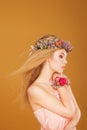 Young model with wreath of bright flowers on her Royalty Free Stock Photo