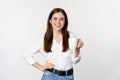 Young moder business woman, office lady holding mug with coffee tea and smiling, standing against white background Royalty Free Stock Photo