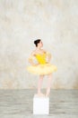 Young modern ballerina in yellow dress posing in the light ballet room Royalty Free Stock Photo