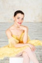 Young modern ballerina in yellow dress posing in the light ballet room Royalty Free Stock Photo