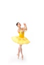 Young modern ballerina with yellow tutu doing the pose on white background Royalty Free Stock Photo