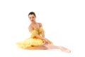 Young modern ballerina with yellow tutu doing the pose on white background. Royalty Free Stock Photo