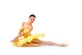 Young modern ballerina with yellow tutu doing the pose on white background Royalty Free Stock Photo