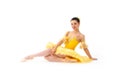 Young modern ballerina with yellow tutu doing the pose on white background Royalty Free Stock Photo