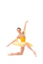 Young modern ballerina with yellow tutu doing the pose on white background Royalty Free Stock Photo