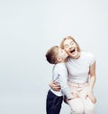 Young modern blond curly mother with cute son together happy smiling family posing cheerful on white background Royalty Free Stock Photo