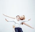 Young modern blond curly mother with cute son together happy smiling family posing cheerful on white background Royalty Free Stock Photo