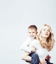 Young modern blond curly mother with cute son together happy smiling family posing cheerful on white background Royalty Free Stock Photo