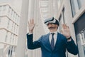 Young modern businessman in VR goggles on head working in augmented reality world and smiling Royalty Free Stock Photo