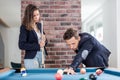 Young modern couple in love playing pool table billiard game Royalty Free Stock Photo