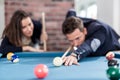 Young modern couple playing pool table billiard game Royalty Free Stock Photo