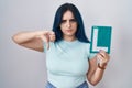 Young modern girl with blue hair holding l sign for new driver with angry face, negative sign showing dislike with thumbs down, Royalty Free Stock Photo