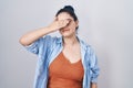 Young modern girl with blue hair standing over white background covering eyes with hand, looking serious and sad Royalty Free Stock Photo