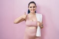 Young modern girl with blue hair wearing sportswear over pink background doing happy thumbs up gesture with hand Royalty Free Stock Photo