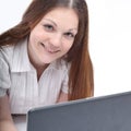 Young modern girl with laptop lying on the floor. Royalty Free Stock Photo