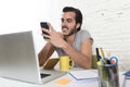 Young modern hipster style student or businessman working using mobile phone smiling happy Royalty Free Stock Photo