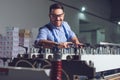 Modern industrial machine operator working in factory. Worker on the machine Royalty Free Stock Photo