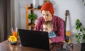 Modern man is working on a laptop, and his little son is sitting on his lap. Concept of family and remote work from home Royalty Free Stock Photo