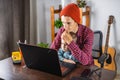 Modern man is working on a laptop, and his little son is sitting on his lap. Concept of family and remote work from home Royalty Free Stock Photo