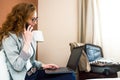 Young modern woman executive on business trip working in hotel room Royalty Free Stock Photo