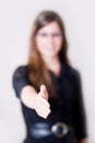 Young modern woman holding hand out to shake. Royalty Free Stock Photo